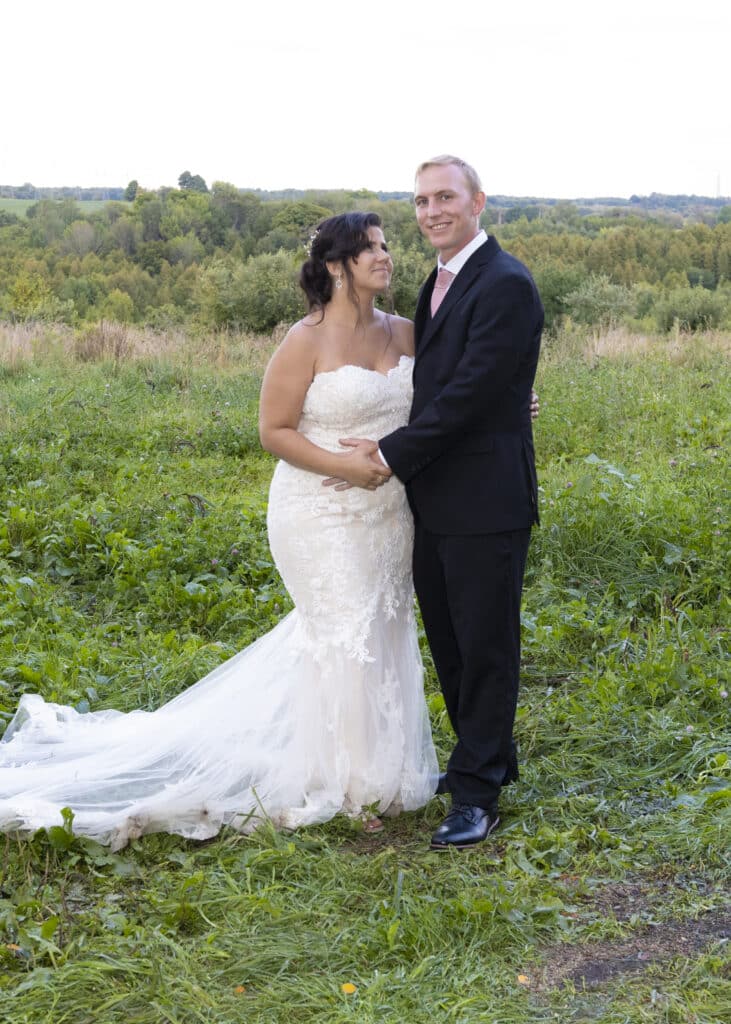 Wedding Photography. Happy Bride and Groom formal Wedding Portrait embrace.