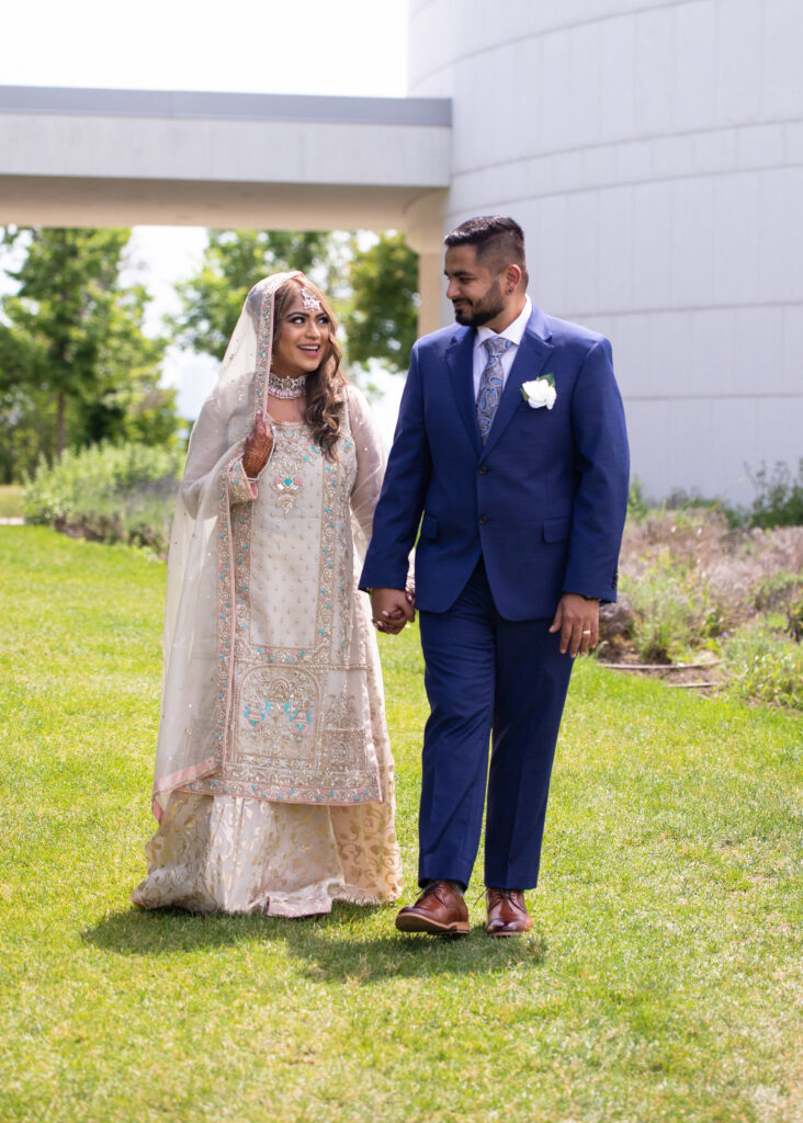 Muslim Wedding Photography. Muslim Couple walking in green Garden.